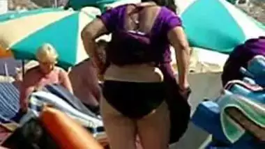 Aunty undresses on foreign beach